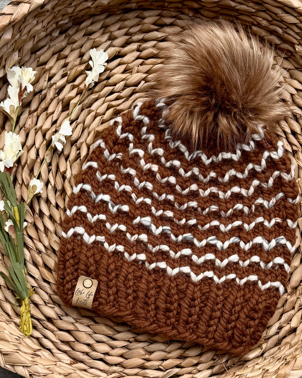 Hand-knit gingerbread brown and cream striped beanie with removable faux-fur pom
